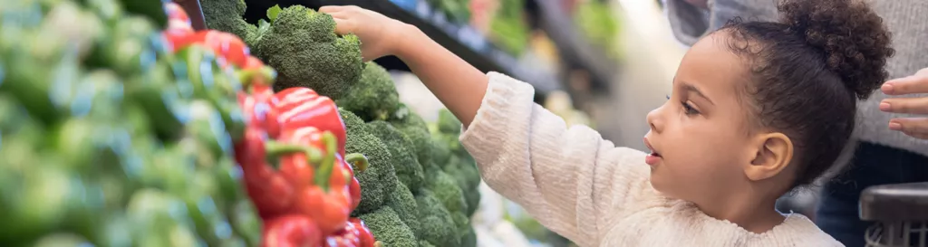 Child picking out produce