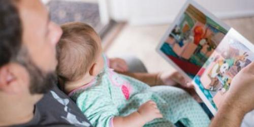 Dad reading to a baby