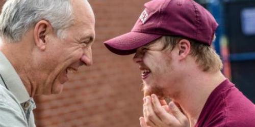 Two men smiling